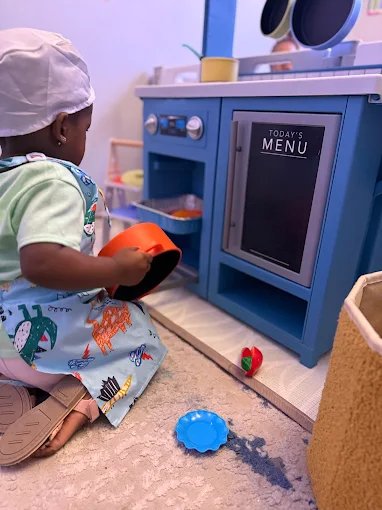 Child playing doctor in role-play activity at Graceland Kids Center